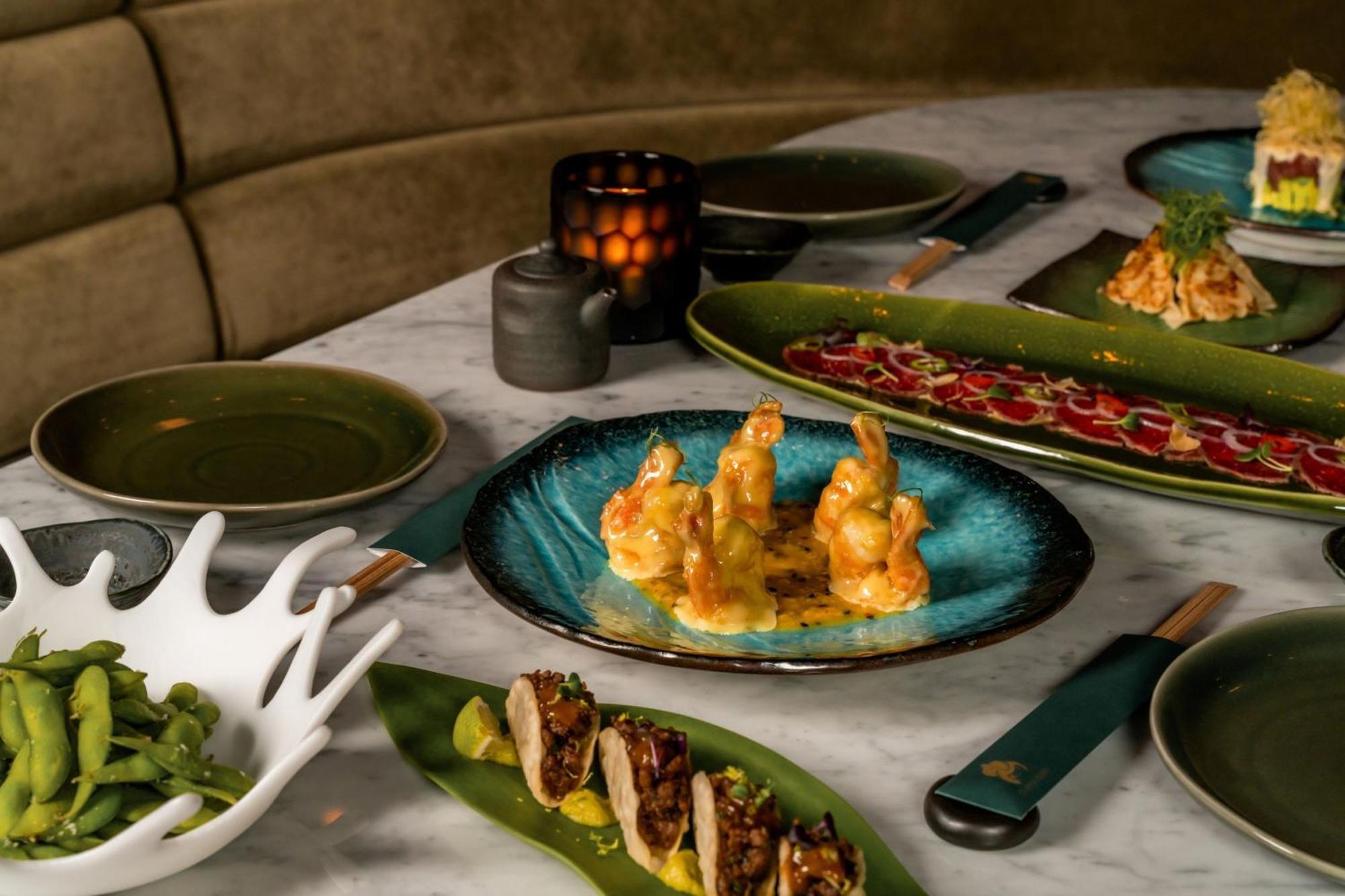 The Dubai Edition Bagian luar foto A selection of dishes at the restaurant